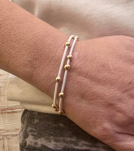 White stretch bracelet with gold beads stack