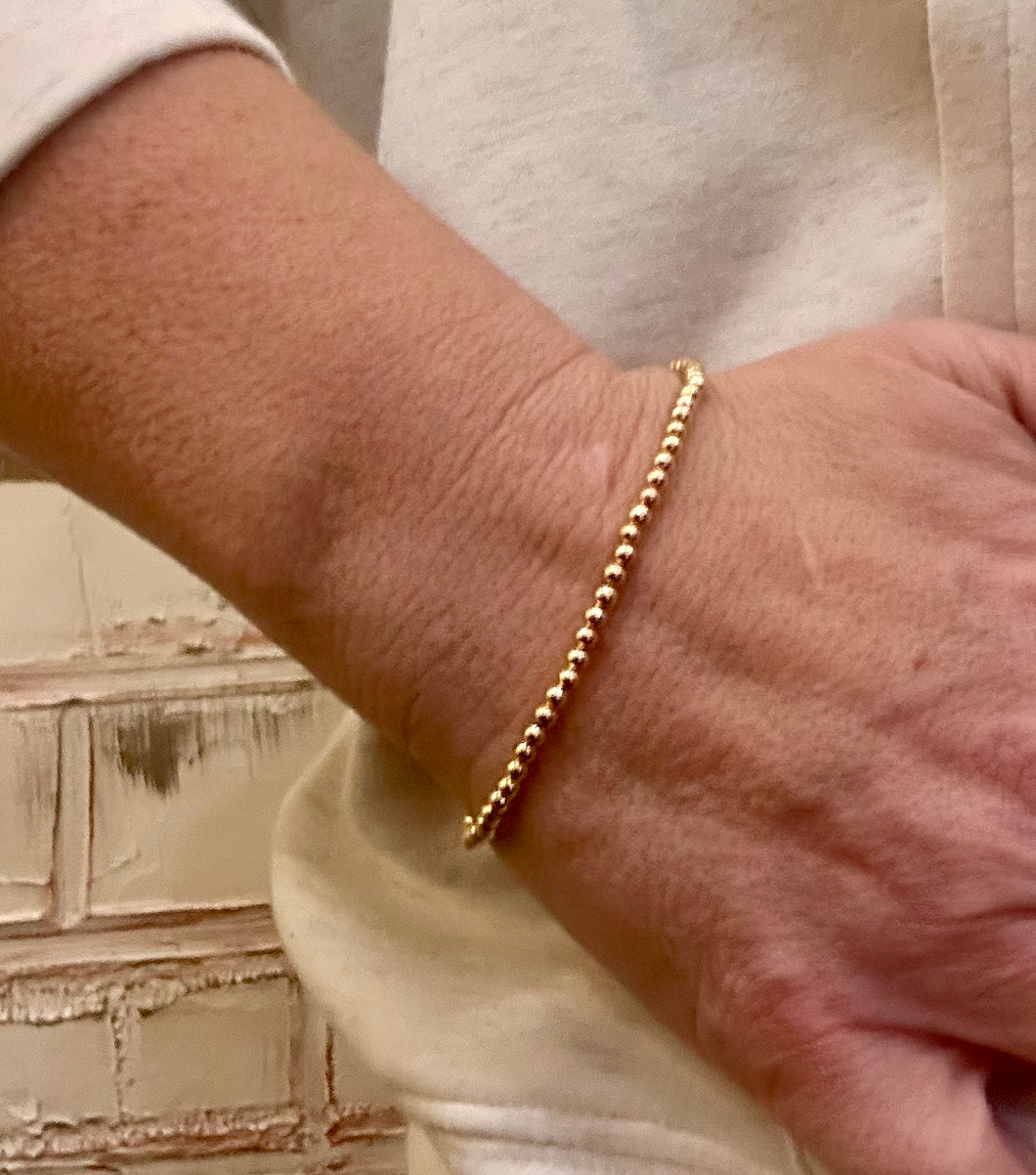 S gold beaded bracelet